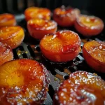Juicy roasted apricots in an air fryer, garnished with rosemary.