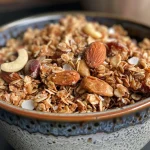 Close-up of a juicy granola bar with visible oats and chocolate chips.