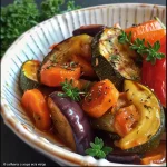 A close-up view of a vibrant bowl filled with roasted vegetables and bulgur.