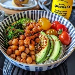 A colorful bowl featuring asparagus, quinoa, avocado, and cherry tomatoes.