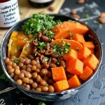 Bowl filled with green lentils and roasted carrots, garnished with spinach and nuts.