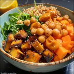 A vibrant Buddha bowl featuring colorful ingredients like quinoa, roasted chickpeas, and fresh vegetables.