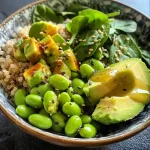 Close-up view of a vibrant Buddha Bowl filled with fresh vegetables and grains.