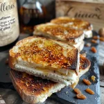 Close-up of grilled goat cheese on rustic bread with toppings.