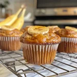 A close-up side view of muffins without butter, showcasing their golden-brown tops.